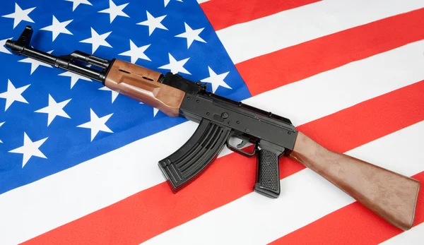 stock image Flag of the United States with a weapon