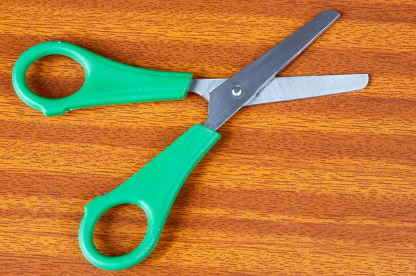Green scissors on a table — Stock Photo, Image