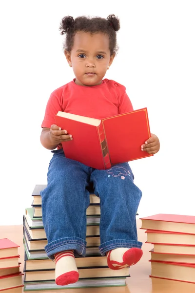 Baby reading sitting on a pile of books Stock Picture