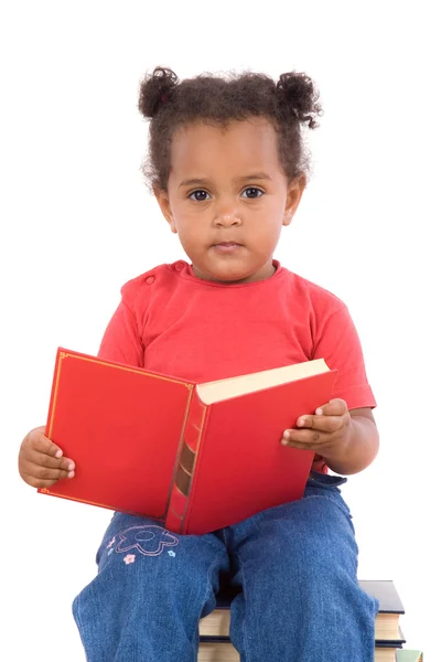 Baby reading sitting on a pile of books Royalty Free Stock Images