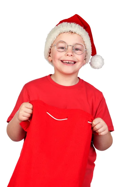 Entzückendes Kind mit Weihnachtsmütze im Sack Stockbild