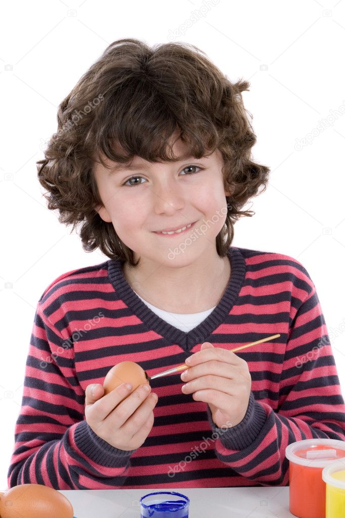 Child adorable adorning Easter eggs