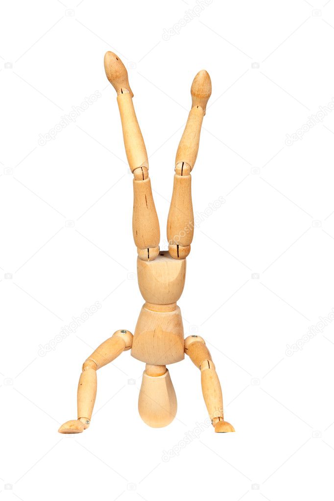 Jointed wooden mannequin doing handstands