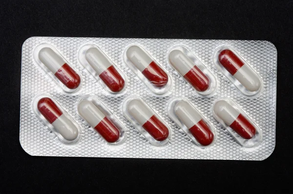 Pills in plastic container — Stock Photo, Image