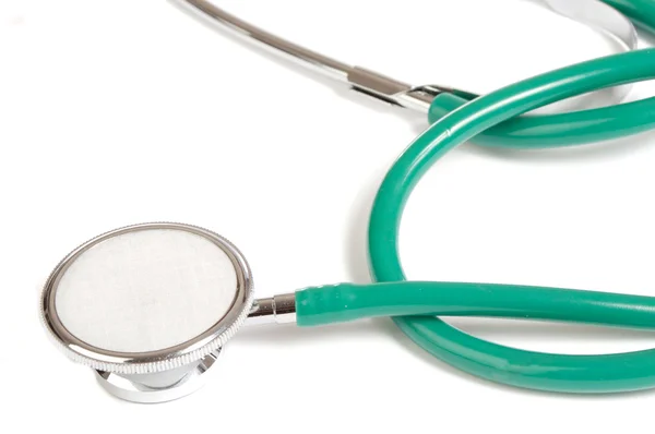 Zielony na białym tle stetoskop — Zdjęcie stockowe