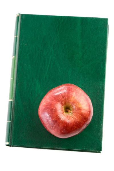 Apfelrot auf grünem Buch — Stockfoto