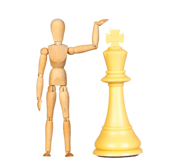 Деревянная кукла с шахматной фигурой — стоковое фото