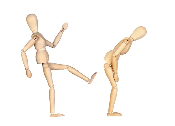 Wooden dummy hitting a kick to another — Stock Photo, Image
