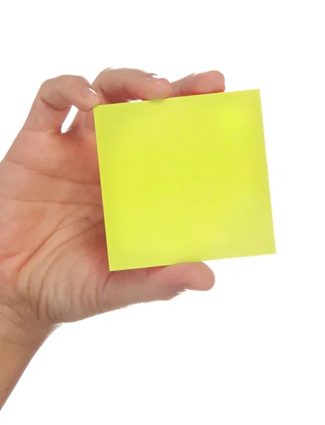 Hand som håller en gul lapp — Stockfoto