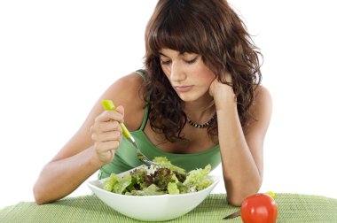 A sad teen eating salad clipart