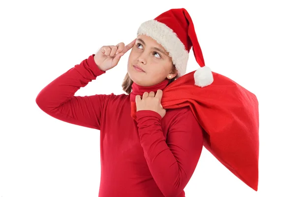 Vacker flicka med hatt av jultomten tänkande — Stockfoto