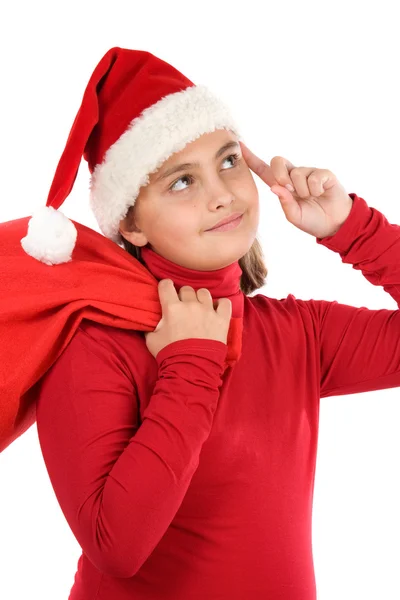 Красивая девушка в шляпе Санта-Клауса думает: — стоковое фото