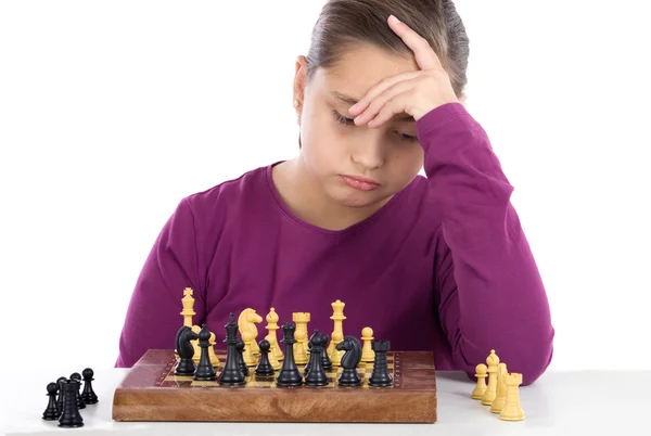 Worried little girl playing chess — Stock Photo, Image