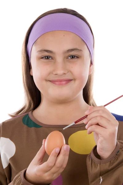 Adorable girl adorning Easter eggs — Stock Photo, Image