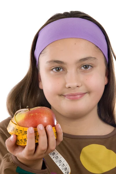 Leuk meisje met een appel met meetlint — Stockfoto