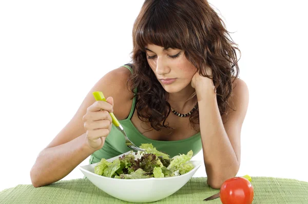 Uma triste adolescente comendo salada — Fotografia de Stock