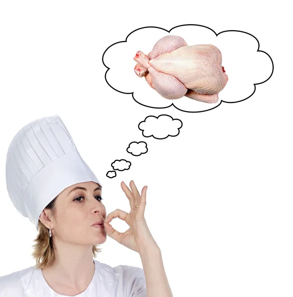 Attraktiva kock flicka med tanke på matlagning en läckra kyckling — Stockfoto