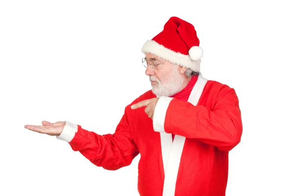 Santa claus wijzend naar de uitgestrekte palm van uw hand — Stockfoto