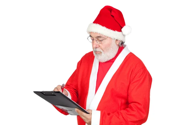 Santa Claus writing on clipboard — Stock Photo, Image