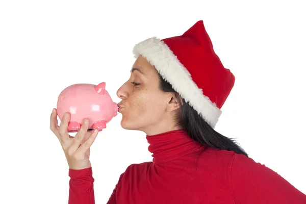 Weihnachtsmädchen gibt Sparschwein einen Kuss — Stockfoto
