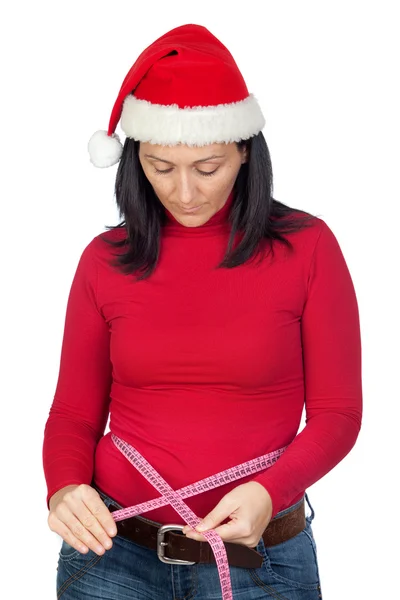 그녀의 허리를 측정 하는 크리스마스 모자와 아름 다운 여자 — 스톡 사진