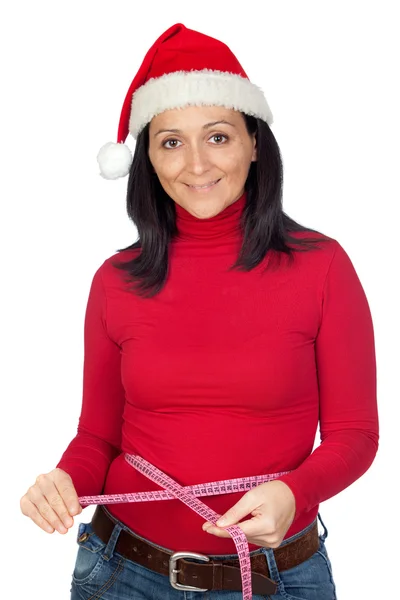 Beautiful girl with Christmas hat measuring her waist — Stock Photo, Image
