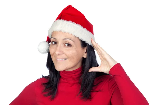 Beautiful woman with Christmas hat making the gesture of listeni — Stock Photo, Image