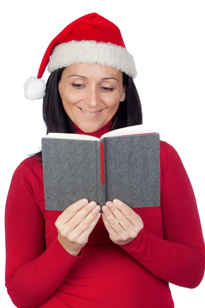 Beautiful girl with Christmas hat reading a book — Stock Photo, Image