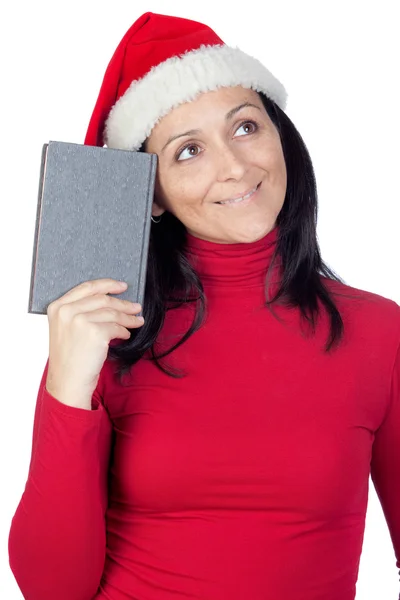 Menina bonita com chapéu de Natal e um livro — Fotografia de Stock