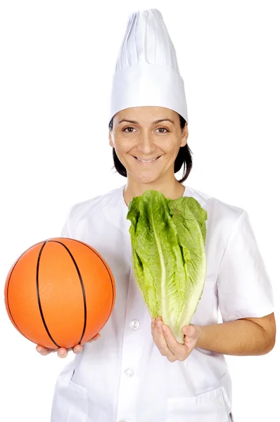 Mulher cozinheira atraente feliz com bola de basquete — Fotografia de Stock