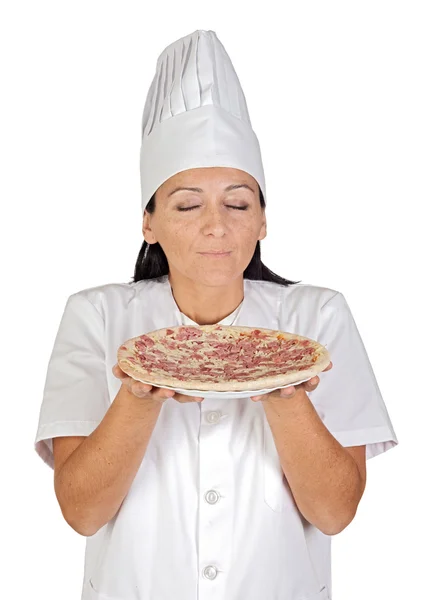 Pretty cook girl smelling delicious pizza Stock Image