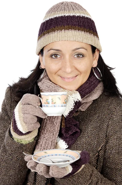Attractive lady sheltered for the winter drinking a tea cup Stock Picture