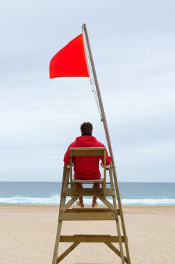 Lifeguard sitting in his chair clipart