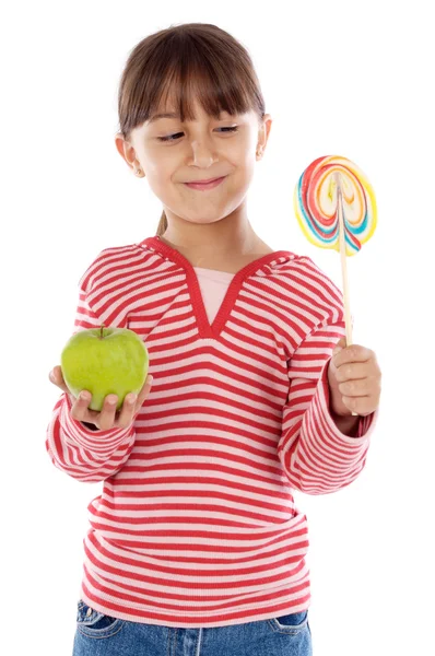 Девушка с леденцом и яблоком — стоковое фото