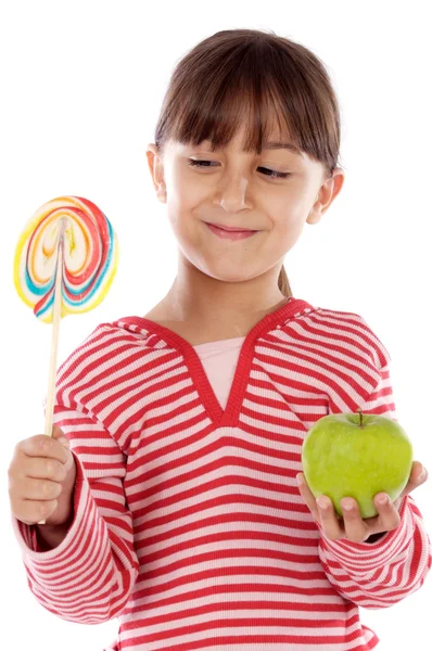 Flicka med lollipop och äpple — Stockfoto