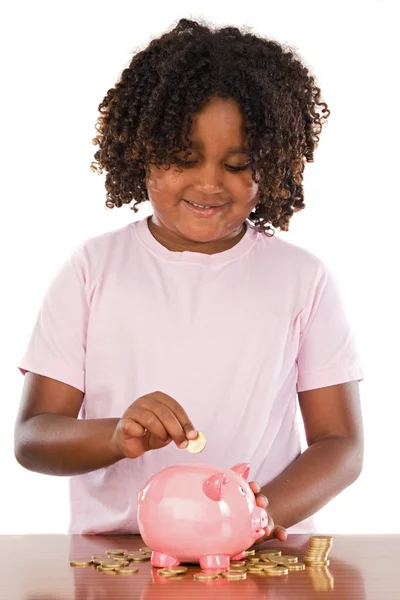 Adorable african girl putting a coin in a piggbank — Stock Photo, Image