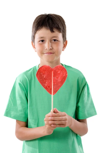 Bambino divertente con lecca-lecca a forma di cuore — Foto Stock
