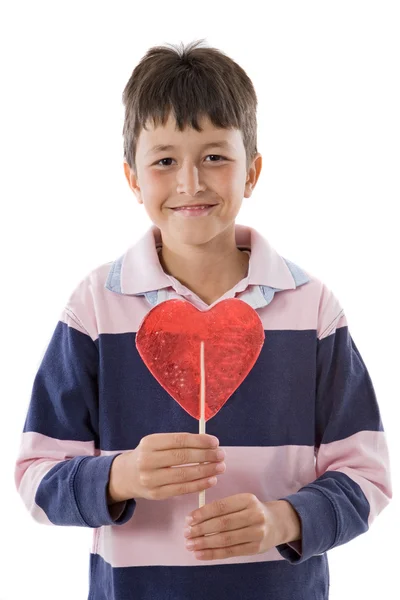 Criança engraçada com pirulito em forma de coração — Fotografia de Stock