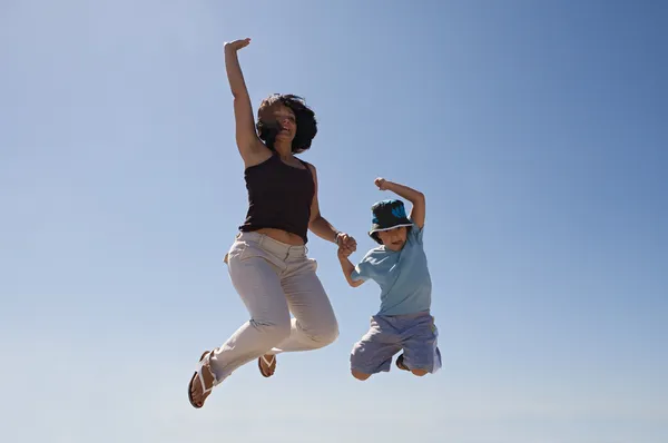 Mother and son jumping — Stock Photo, Image