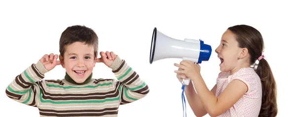 Little girl shouting through megaphone at a boy — Stock Photo, Image