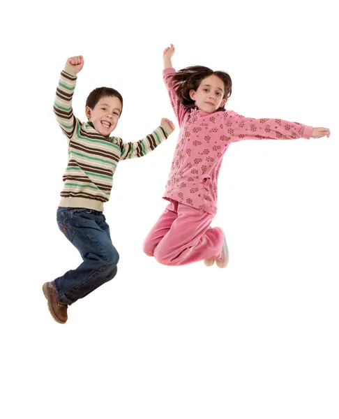Двоє щасливих дітей стрибають одночасно — стокове фото