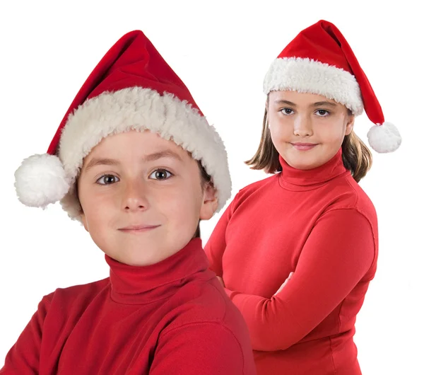 Duas crianças com boné de Natal — Fotografia de Stock