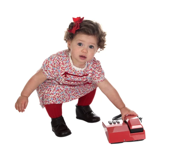Funny babymeisje met rode telefoon — Stockfoto