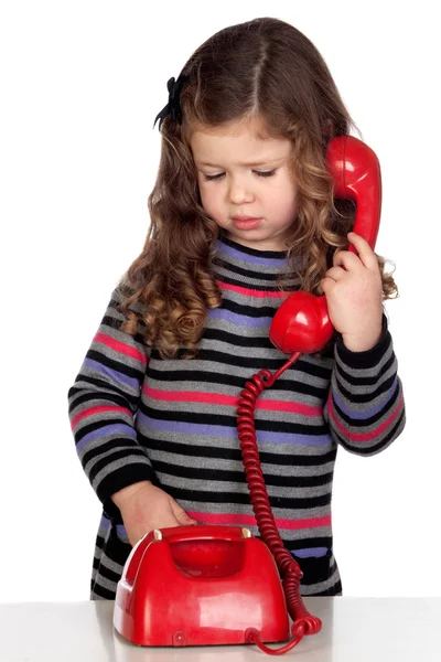 Schattige baby met een rode telefoon — Stockfoto