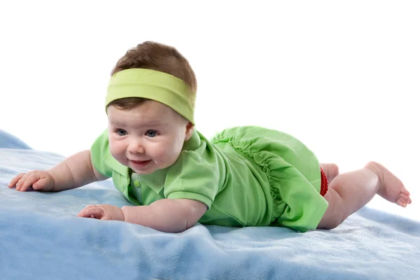 Meisje van de baby lacht liggen gezicht beneden — Stockfoto