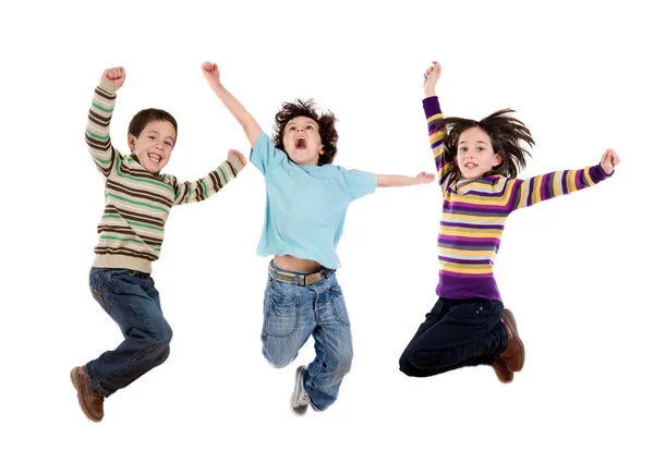 Tre bambini felici che saltano contemporaneamente Immagini Stock Royalty Free
