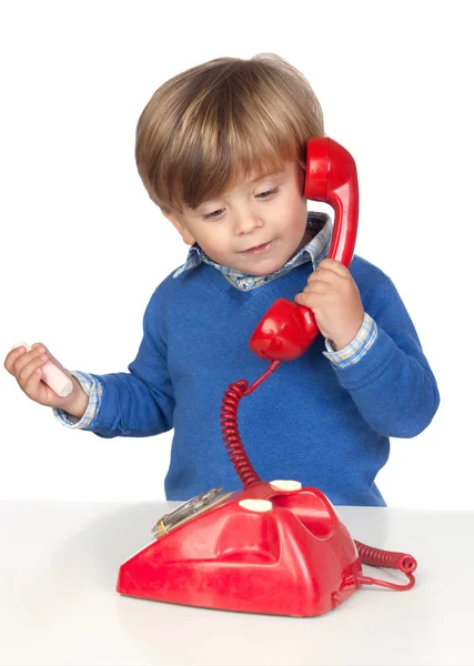 Schönes Baby mit rotem Telefon — Stockfoto