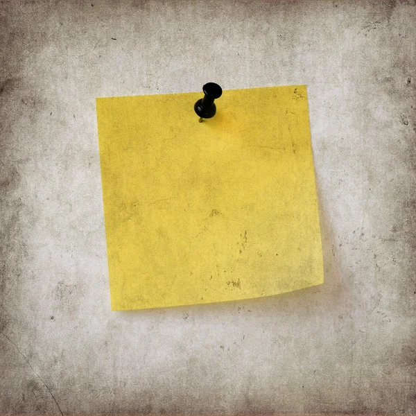 Yellow note over grunge background