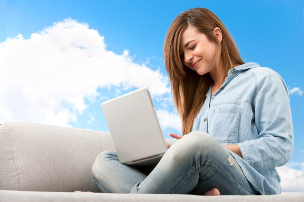 Young woman with laptop outdoors.