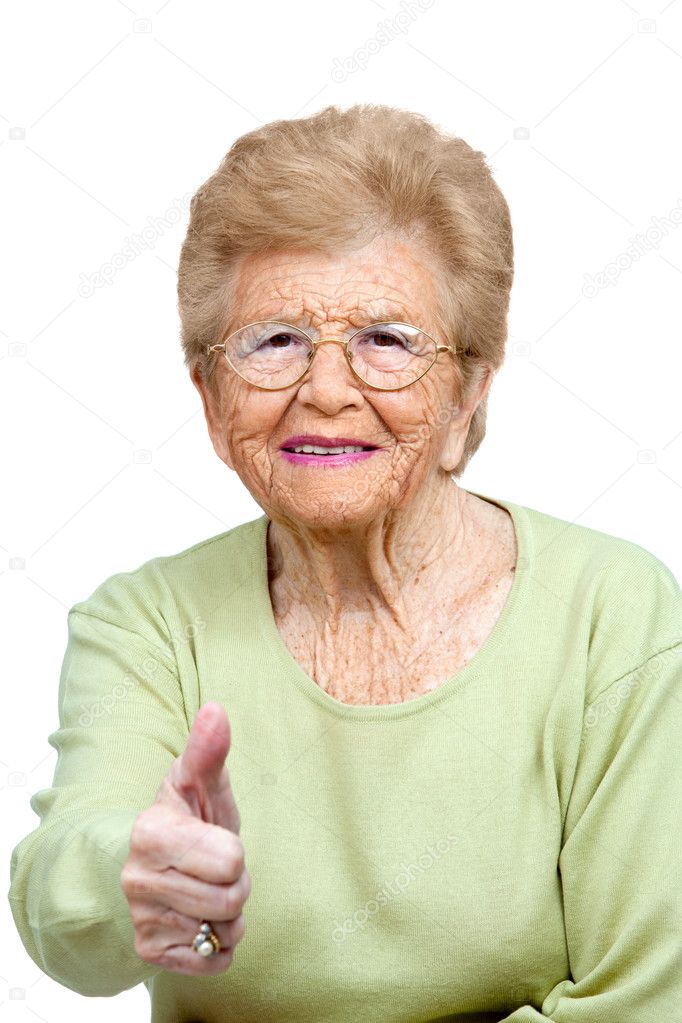 Elderly woman showing thumbs up.